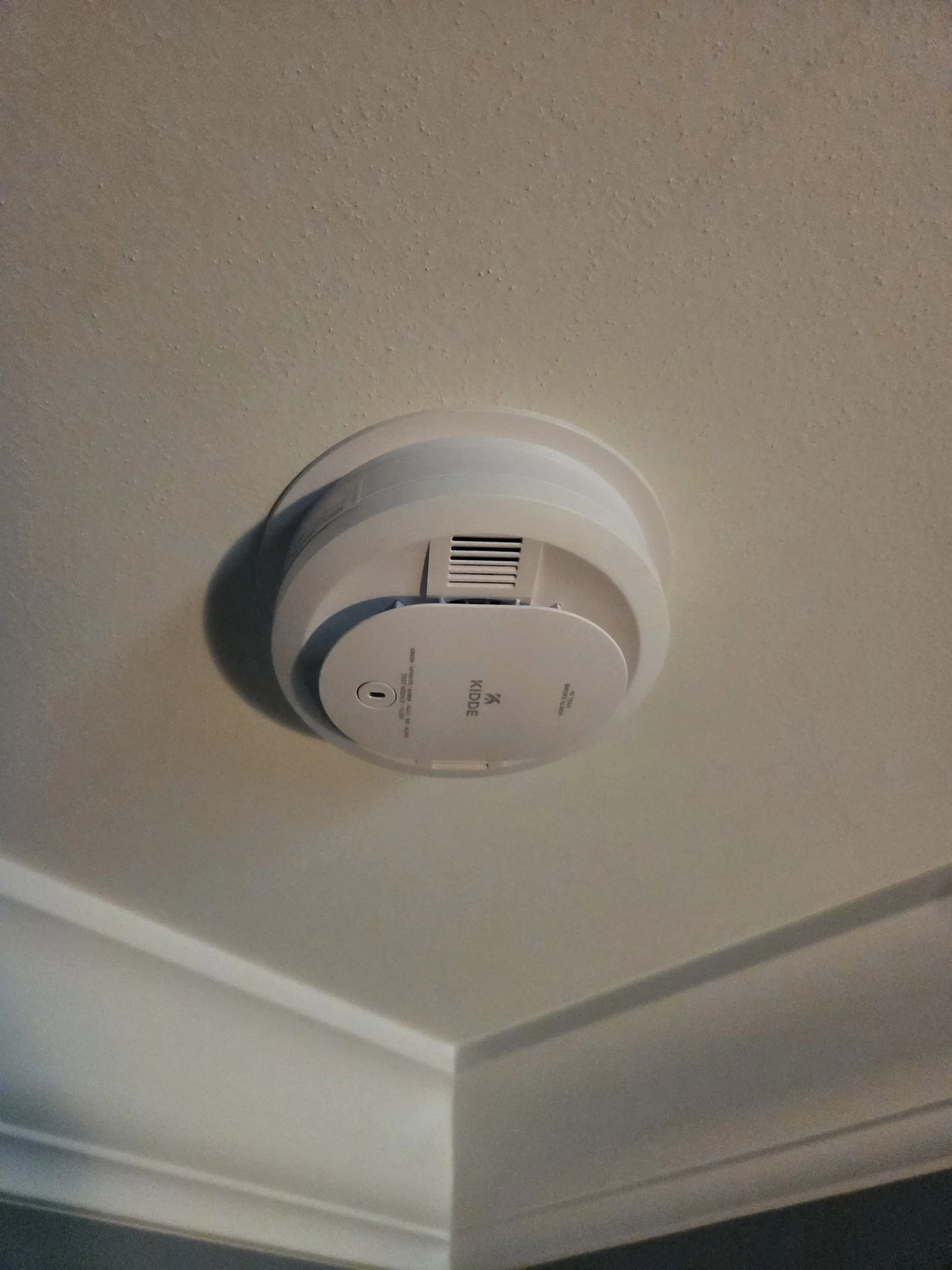 Smoke detector chirping on a residential ceiling