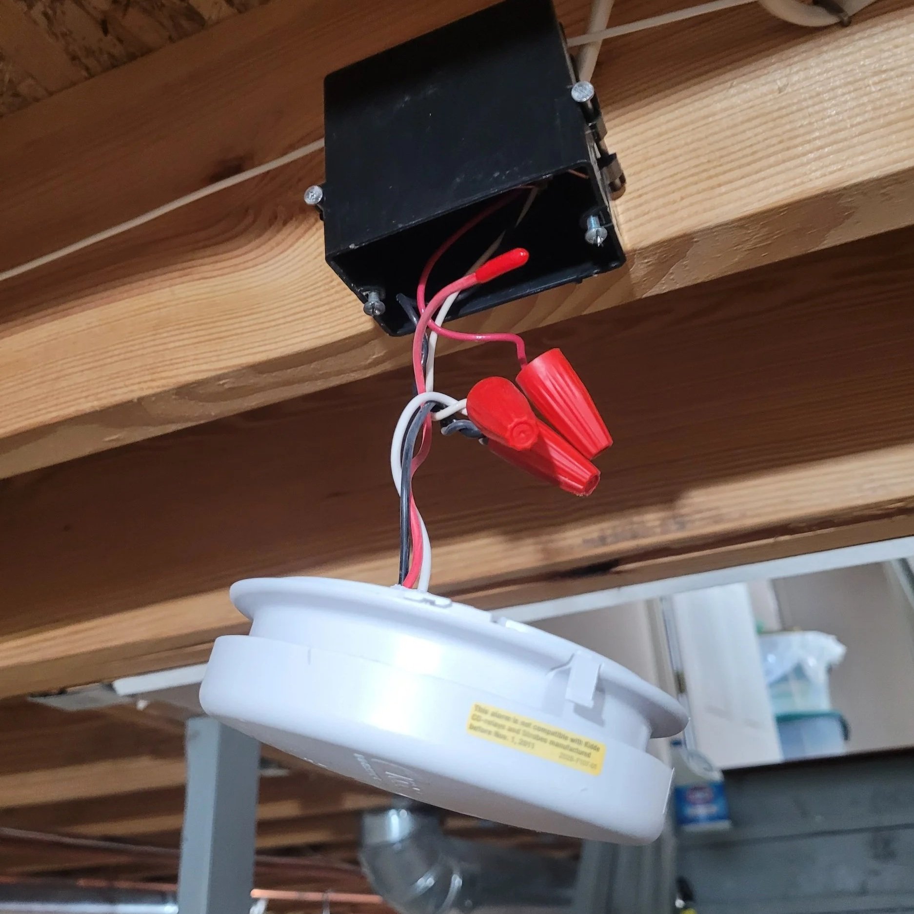 Picture of fixing smoke alarm hanging from ceiling