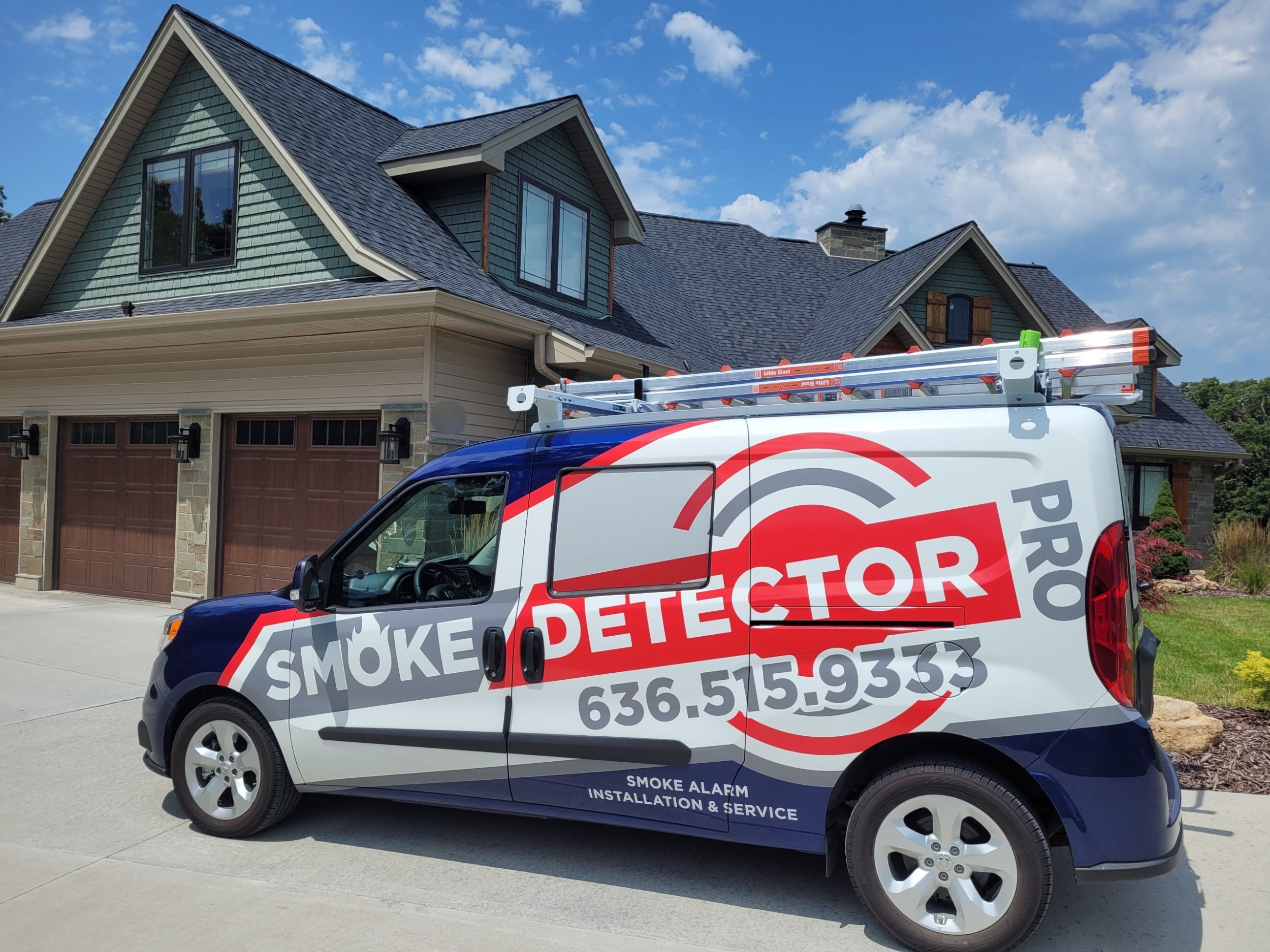 smoke detector inspection and maintenance vehicle in front of a customer's home.