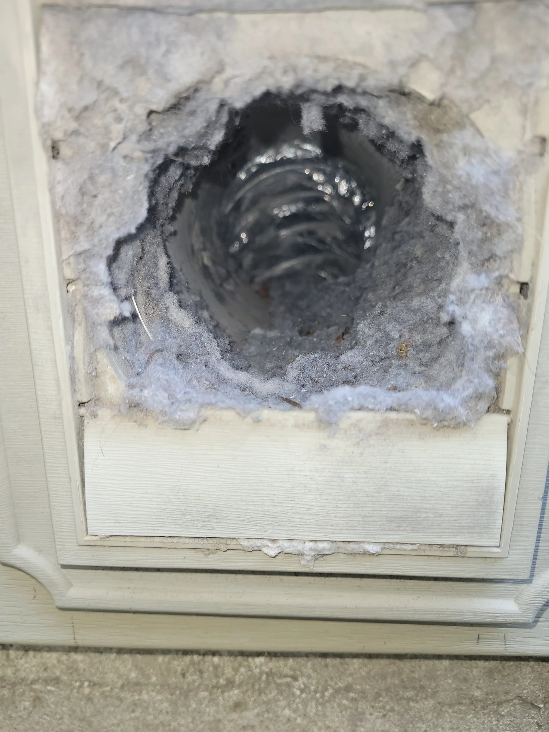 A dryer vent full of lint possible fire hazard