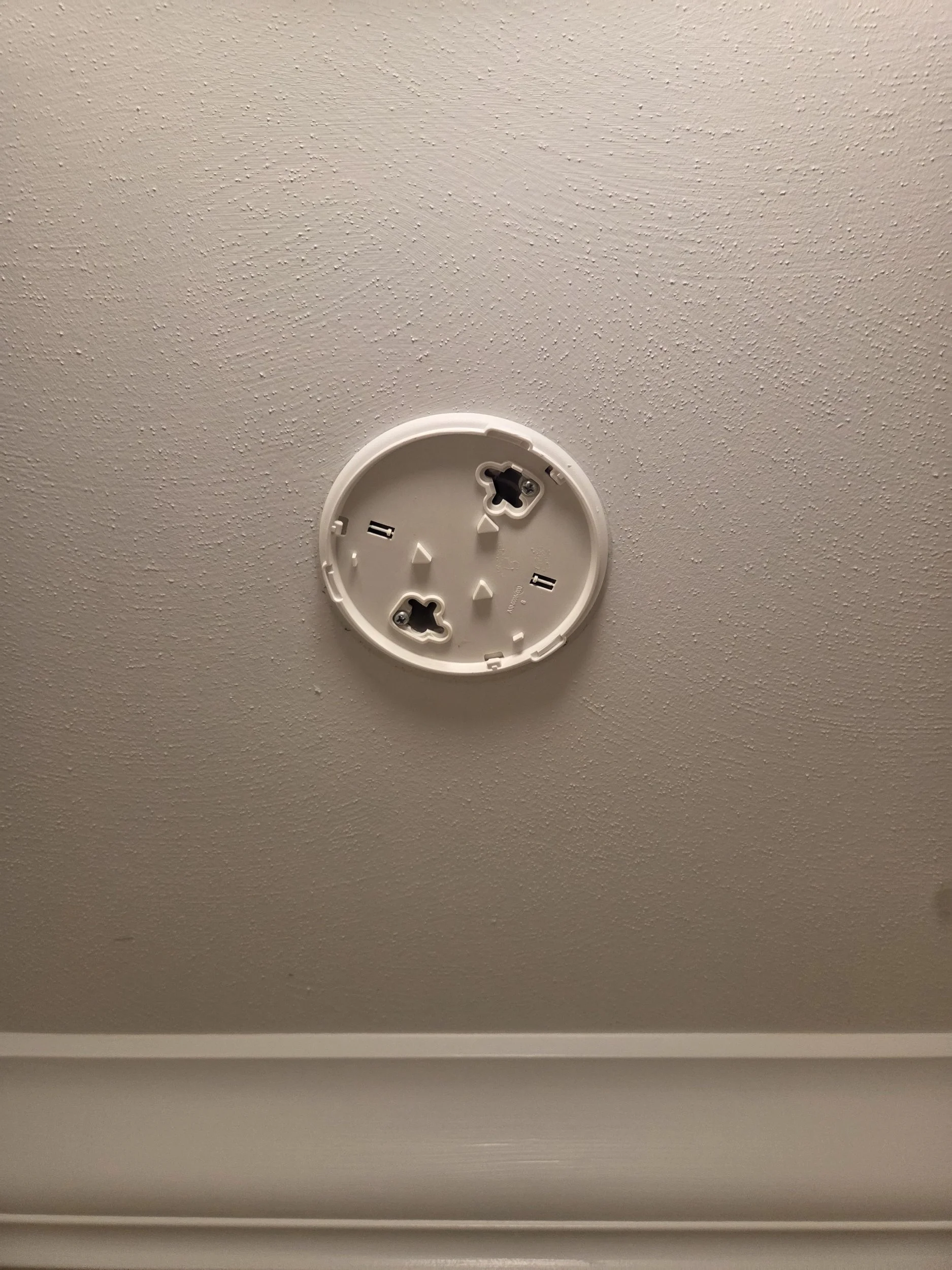 Hardwired smoke detector with battery backup installed on ceiling