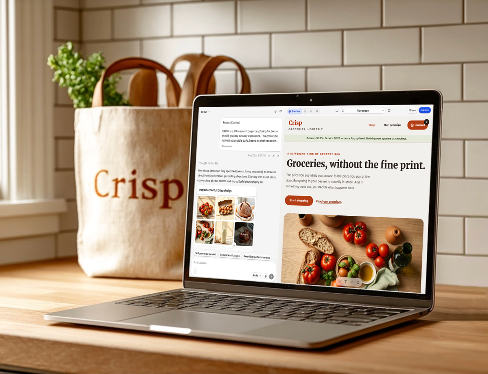 A laptop on an oak countertop showing the CRISP build in Lovable: an AI chat panel beside a grocery site prototype. A linen Crisp tote with produce sits behind it.