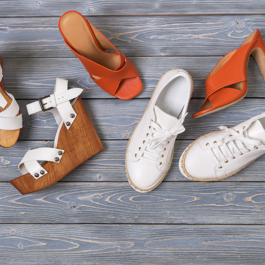 A variety of female shoes scattered on the floor.