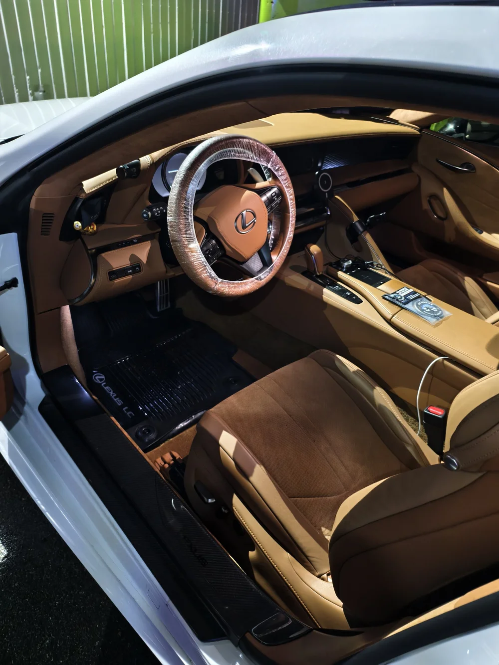 Tan Lexus seating, steering wheel and cabin trim