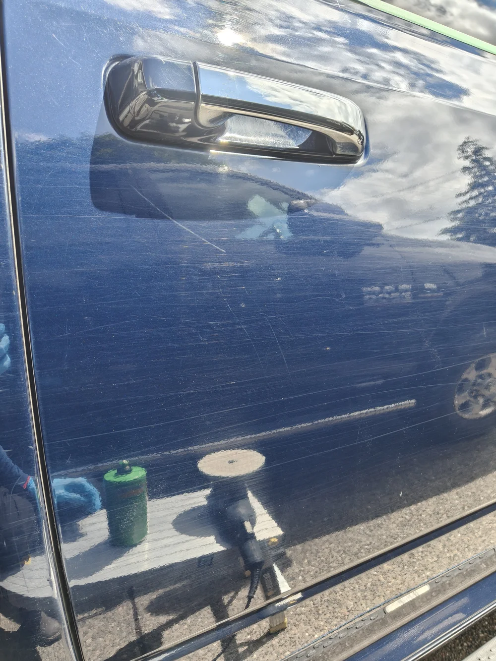 Before paint correction: blue vehicle door finish