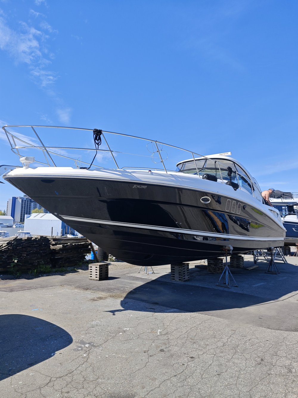 Black-and-white boat on land during a polishing project