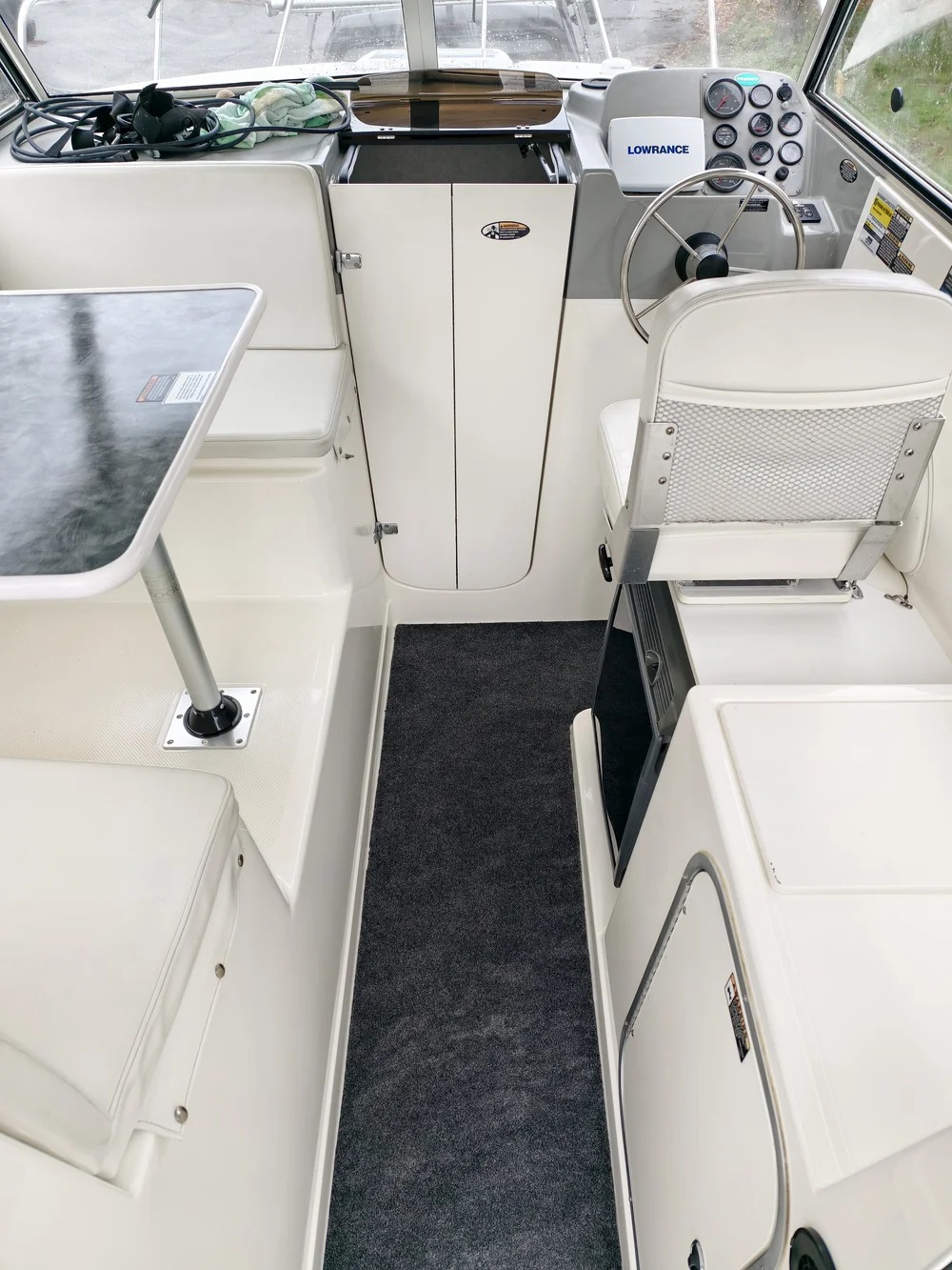 White boat cockpit with seating, instruments and a steering wheel