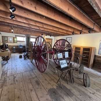 A historical artifact with a wheel inside the Rico Historical Society Museum