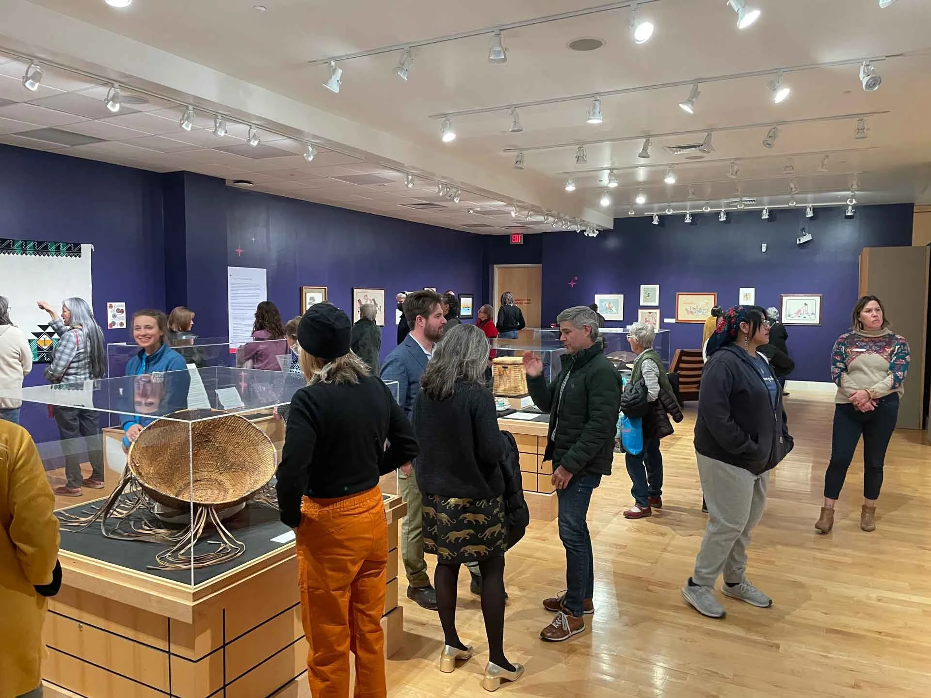 people walking around a room looking at artifacts