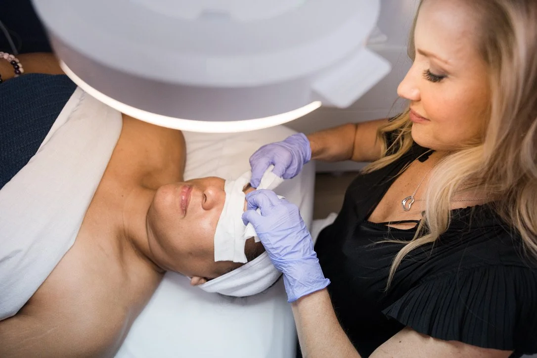 Client receiving a professional facial treatment at Nourish Lifestyle Spa in Dallas.