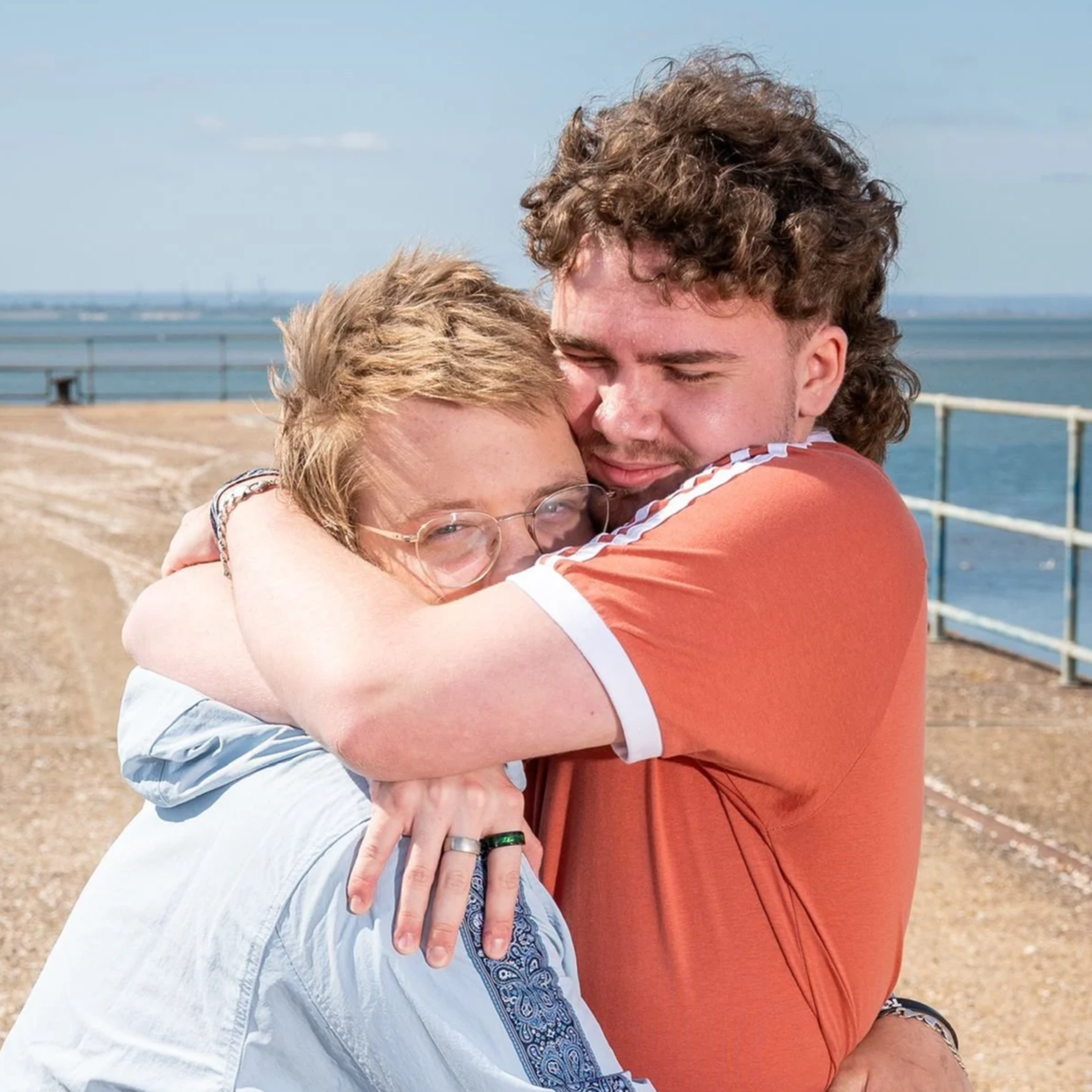 Nathan Bennett giving Denny Keil a hug