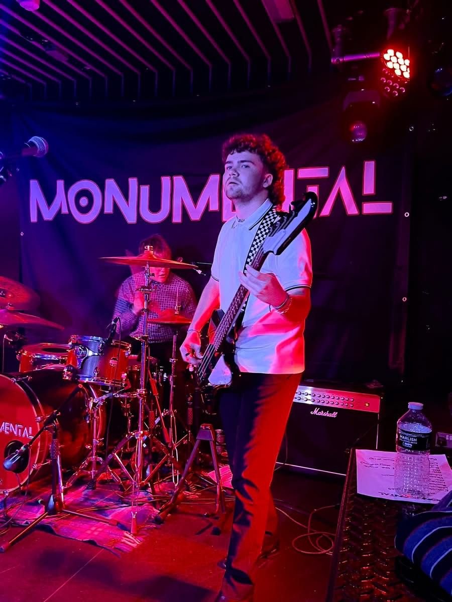 Nathan Bennett on stage with Monumental banner behind