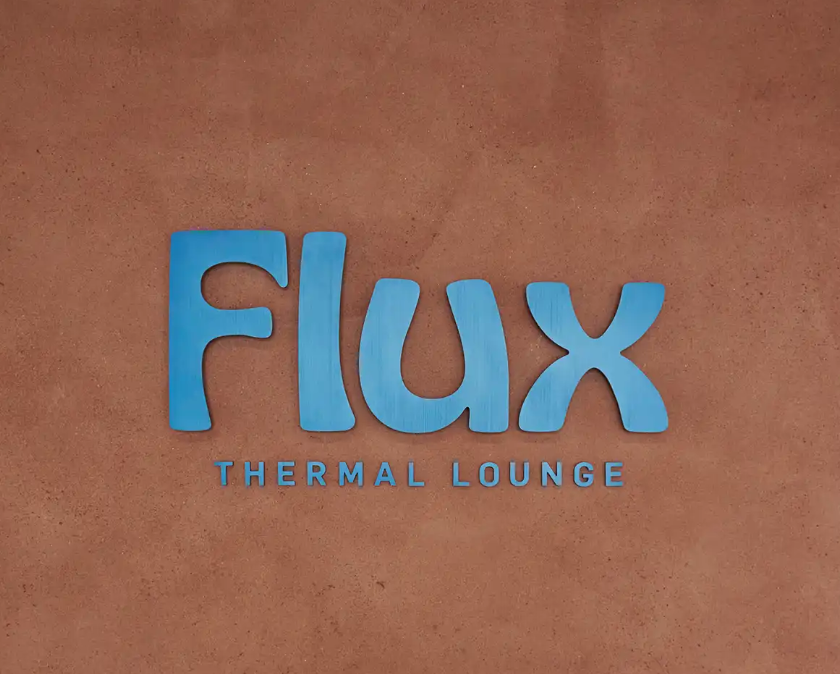 Sign for Flux Thermal Lounge with blue letters on a brown background