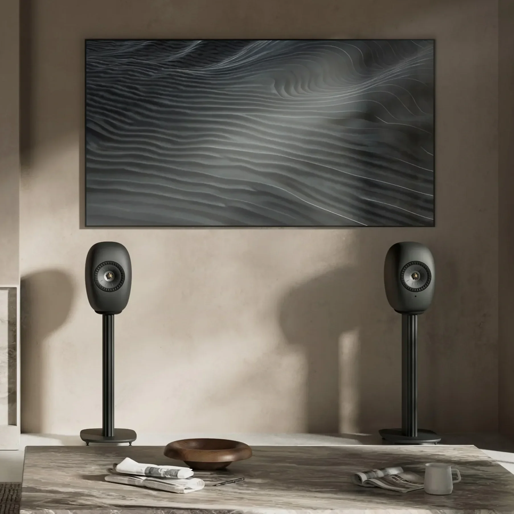 The KEF LS Luxe connected speakers in Black finish on Black stands in a luxurious living room setting