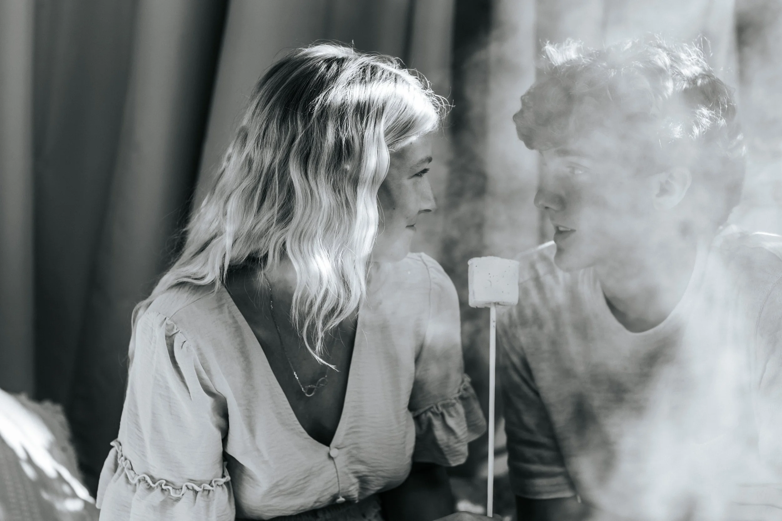 Black and white portrait of a couple by a smoky fire during their fall photo session