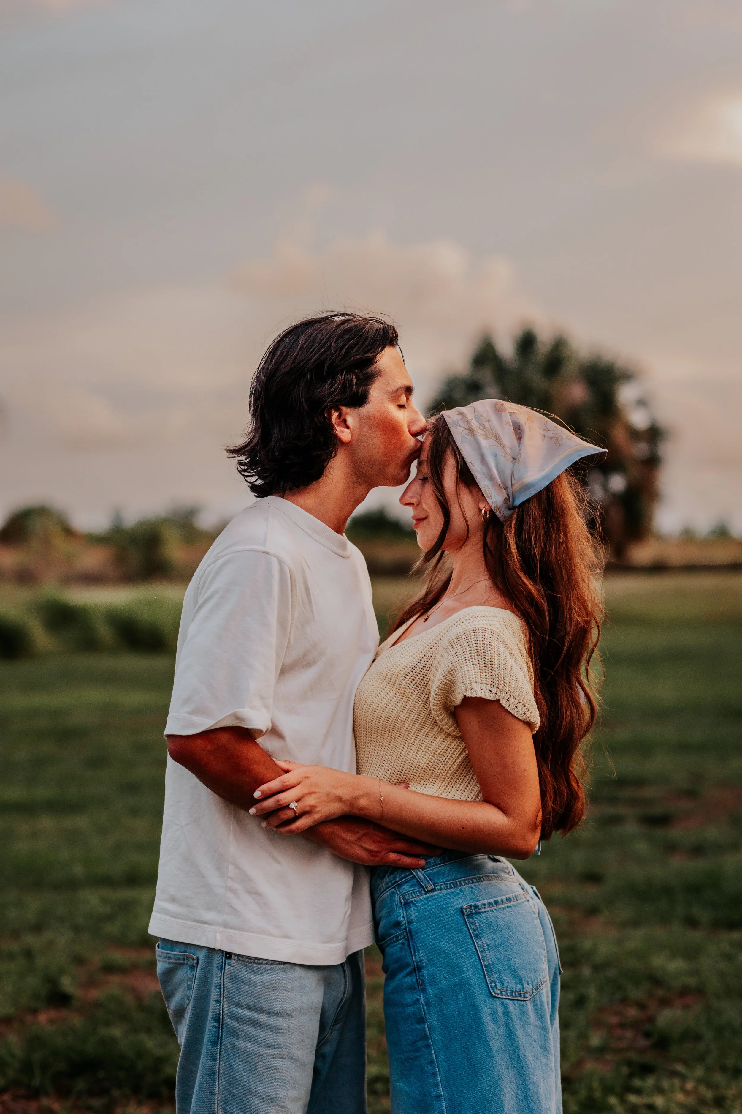 couple sharing a quiet forehead kiss during a film-inspired engagement session in central florida, tampa photographer