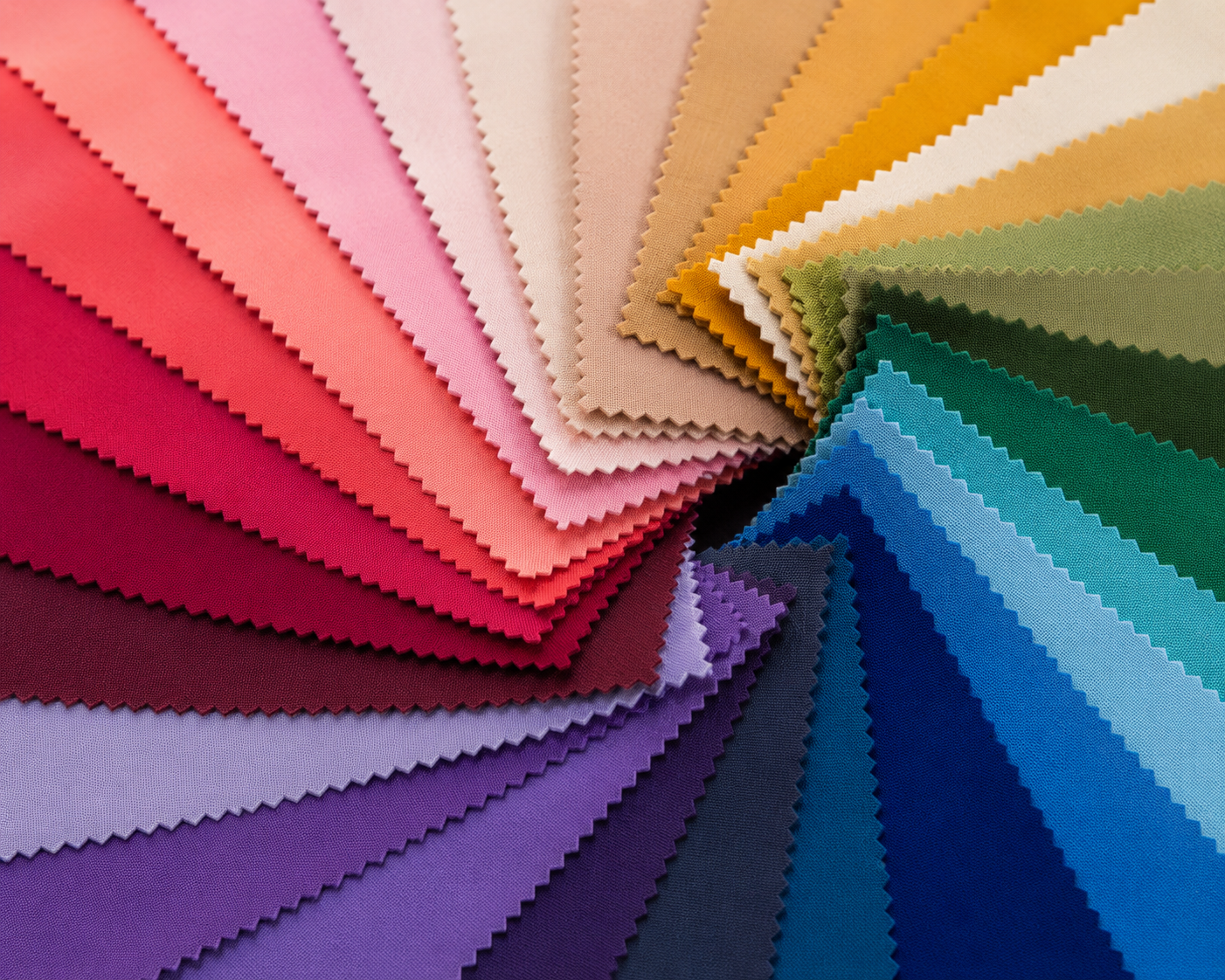 Color swatches arranged in a fan display, featuring shades of pink, red, purple, beige, yellow, green, blue, and black.