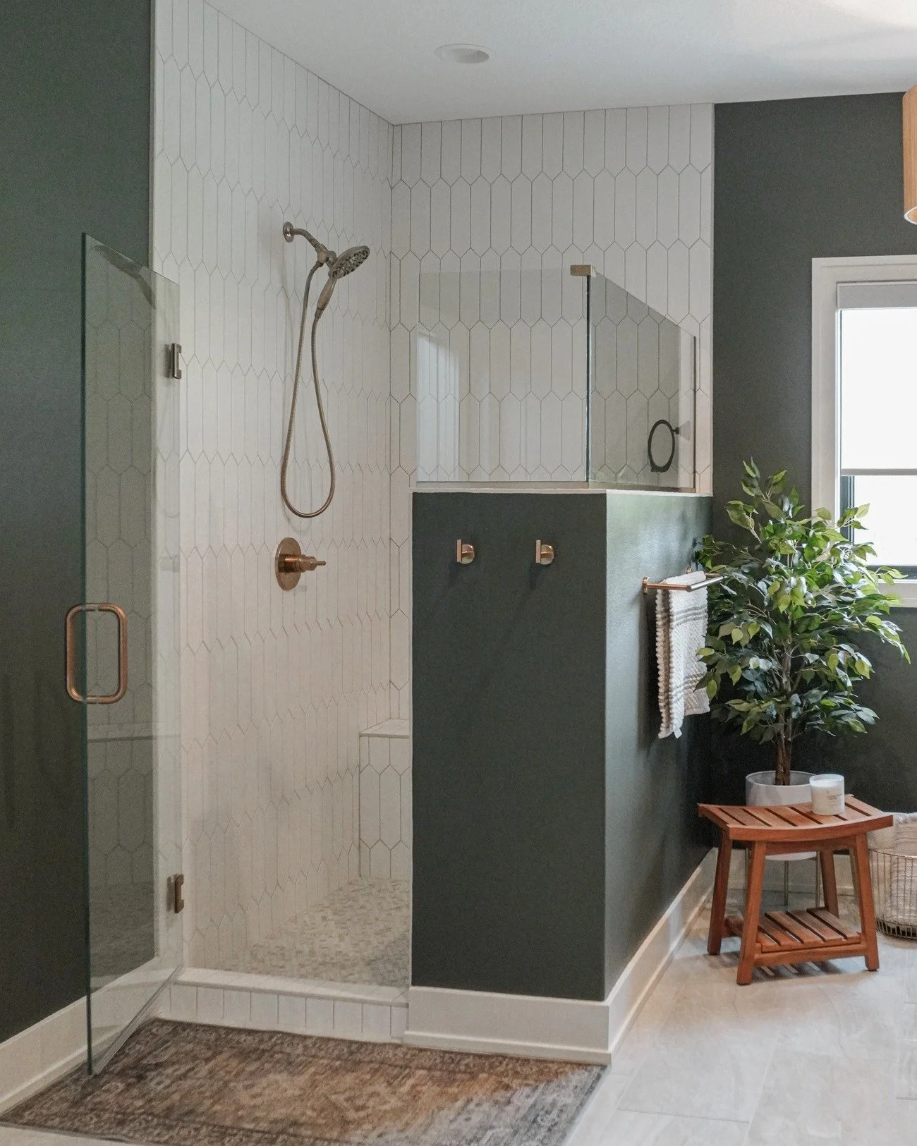 A primary bath made to unwind in &mdash; crisp white tile meets moody green walls for a timeless contrast that feels both fresh and serene. ✨🌿🤍
.
.
.
 #designtrends #interiordesigner #interior_and_living #style #cozyhome #newbuildhomes #moody_tones