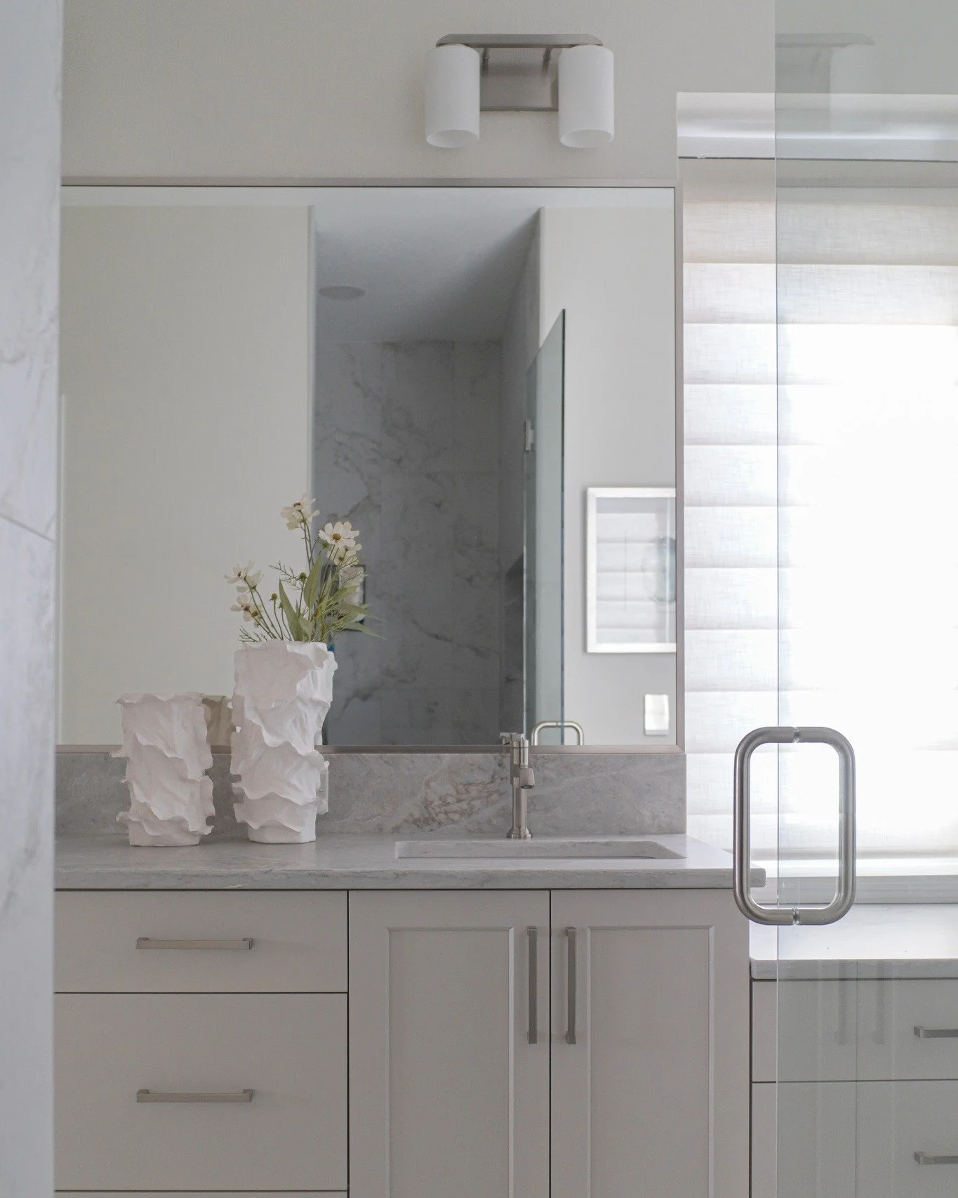 Mondays are for slow mornings in your dreamy primary bathroom 🤍

 Soft, relaxing tones set the foundation, while classic finishes keep the space feeling elevated for years to come.  Styled simply with neutral vases and fresh greens to bring in life 