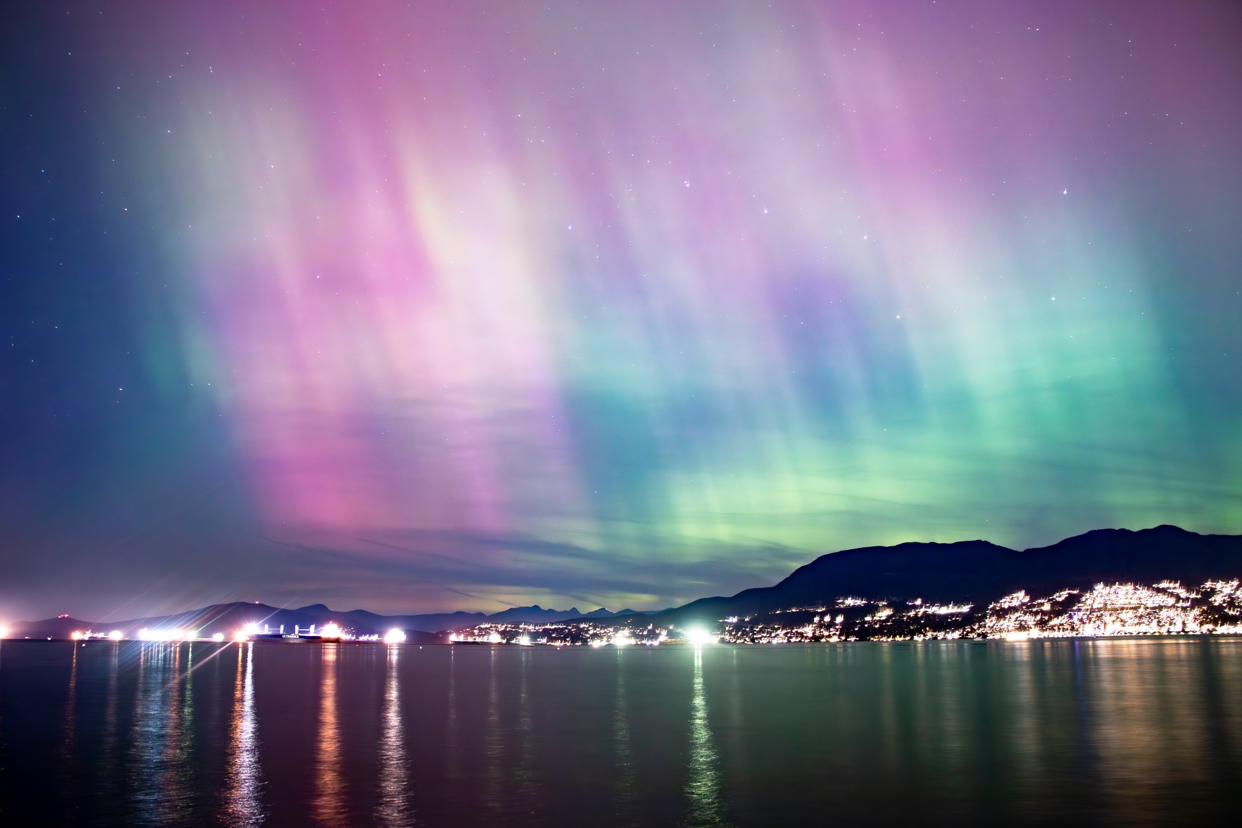 DECEMBER: Aurora borealis at Kitsilano beach, Vancouver | Scientists predict that for next couple of years, the aurora borealis activity will continue to peak. I took this photo with my Canon 77D, a tripod, and using a 15 second exposure to capture t
