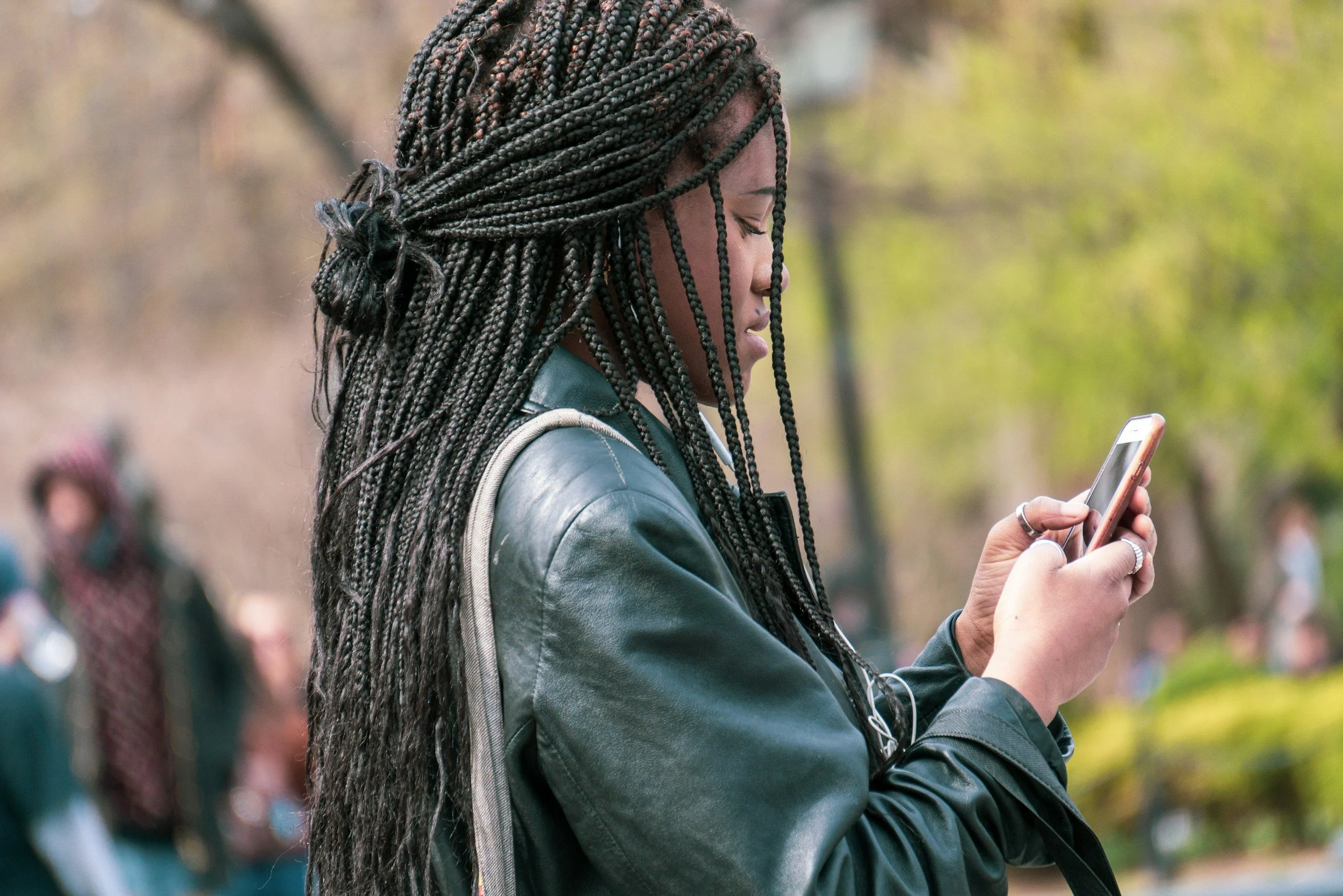Black woman texting on cell phone