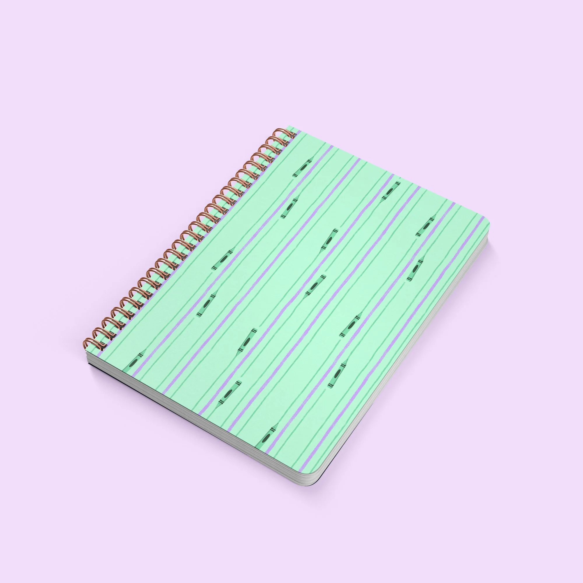 A journal with the cover featuring a pattern of crayons drawing stripes