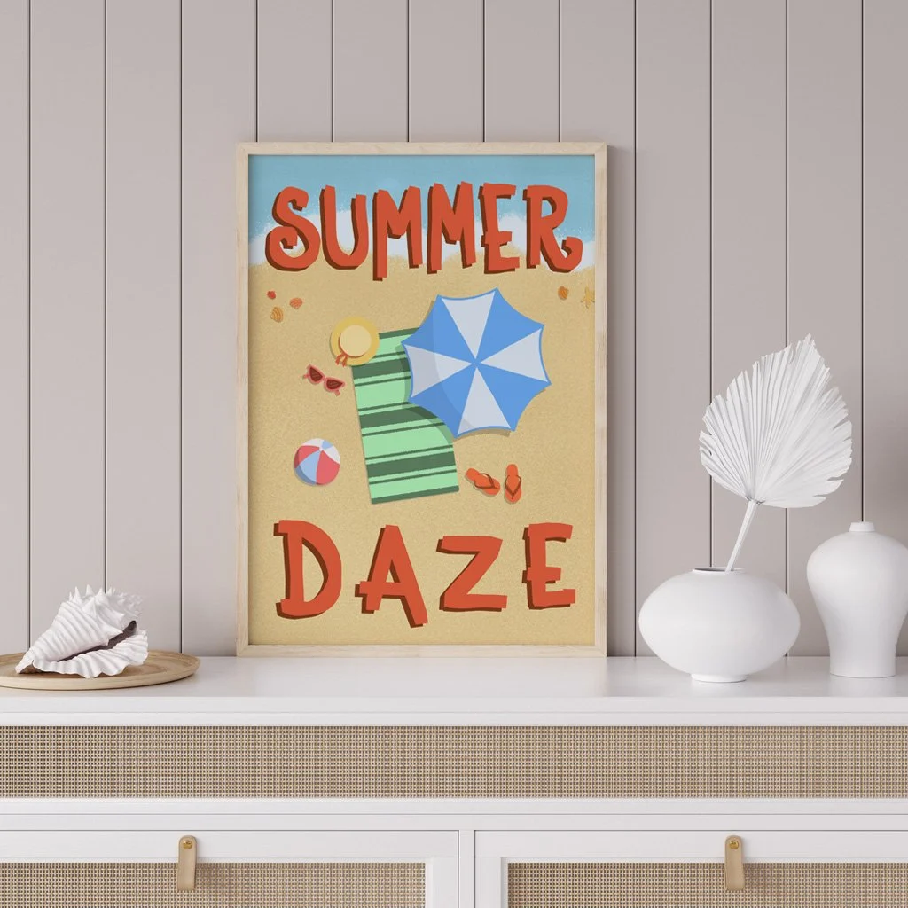 Wall art on a shelf showing a beach scene from above with hand lettered text "Summer Daze"