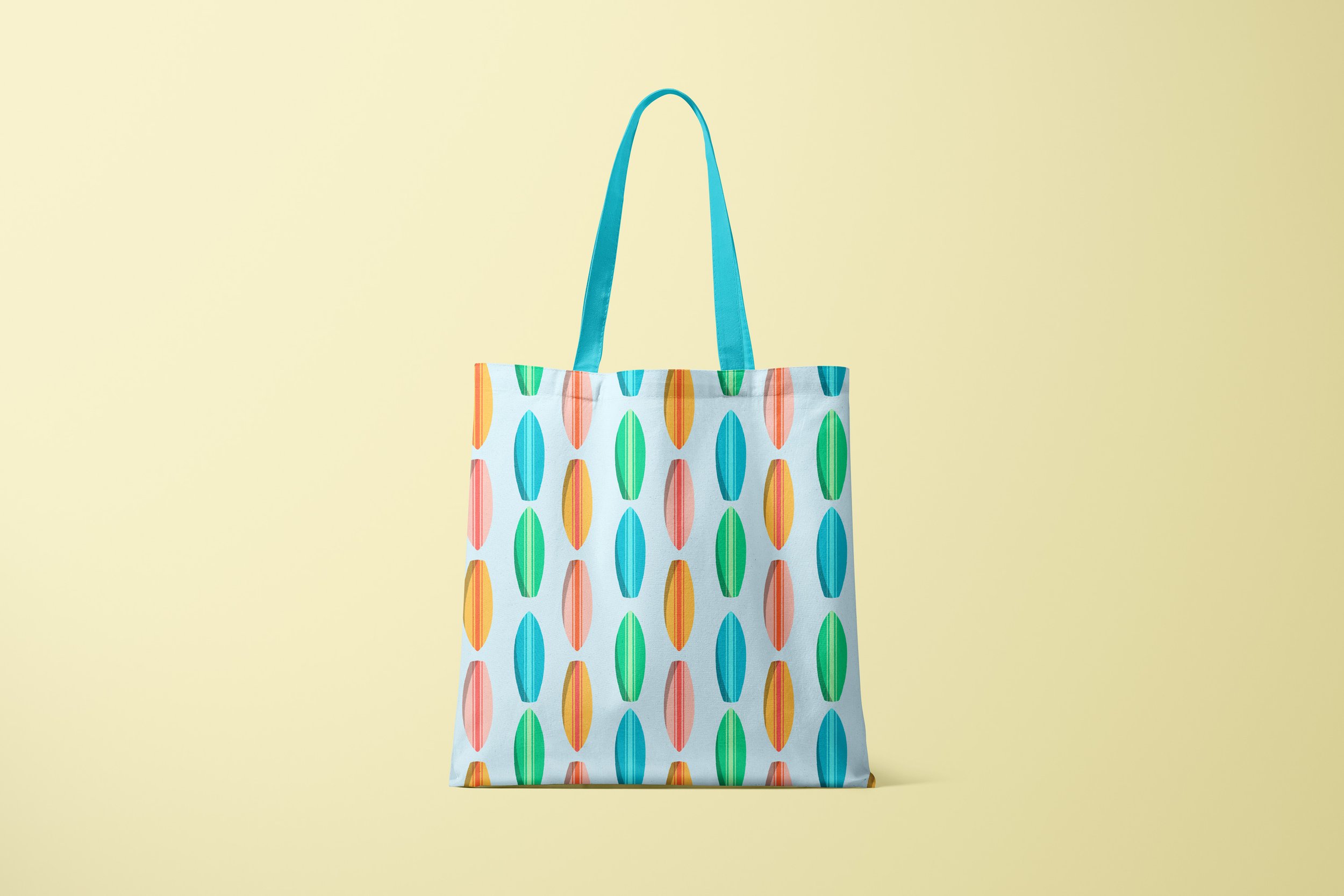 A tote bag with a pattern featuring colorful surfboards