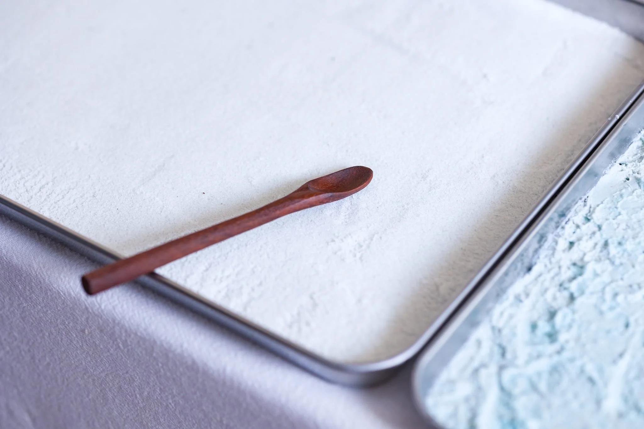 VECETO: Edible scenography, durational tableau. Pea flower salt and spirulina cream sit pale blue on ceramic trays.