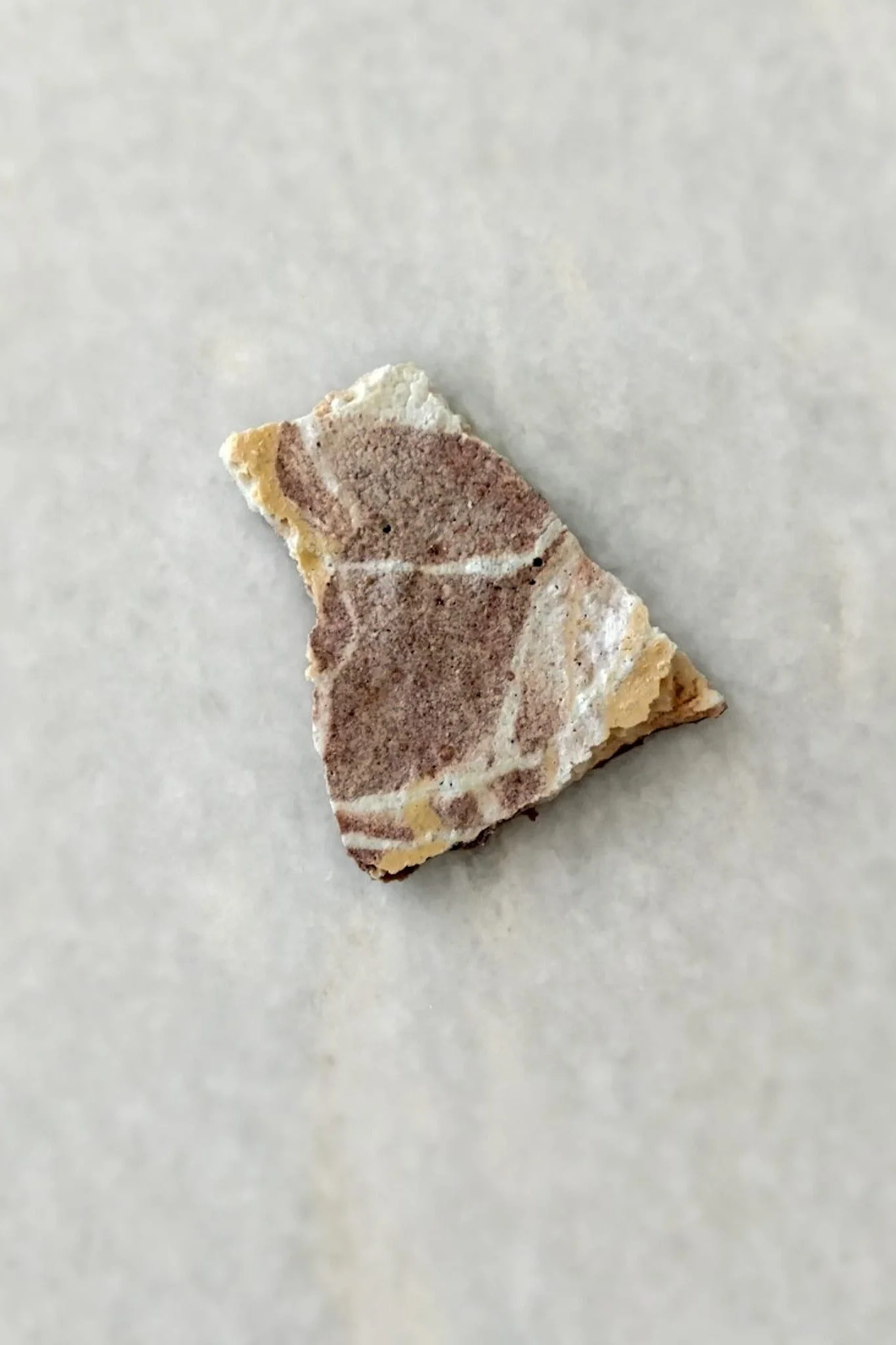 Fracture reveals it: broken fragment of sculptural meringue, porous as quarried stone yet fully edible. VECETO, New York.