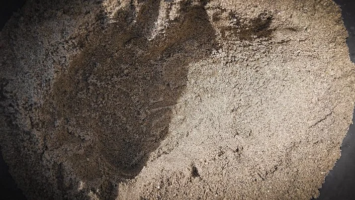Sand mould holding a negative form before concrete is poured.