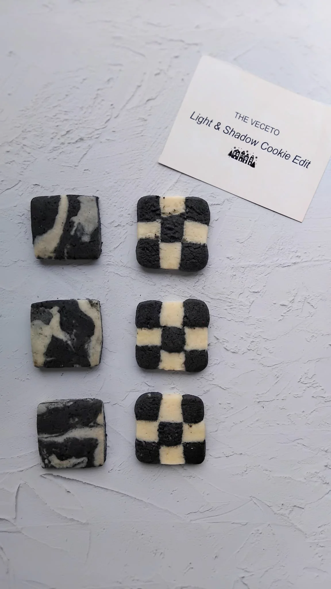 Minimalistic black and white cookie patterns in marble and checkerboard
