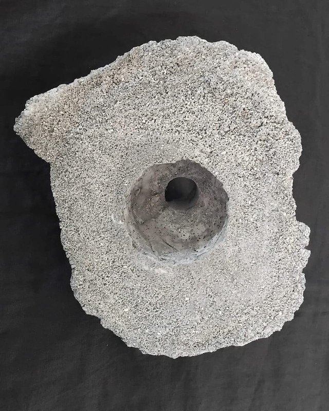 Cast concrete vessel holding broccolini, and the same vessel standing empty after the table has taken it.