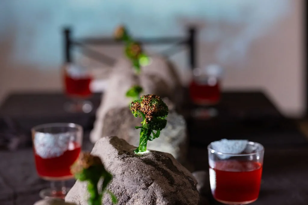 An immersive art installation by Veceto: blackberry-sage elixir rimmed with icy blue pea flower lace.
