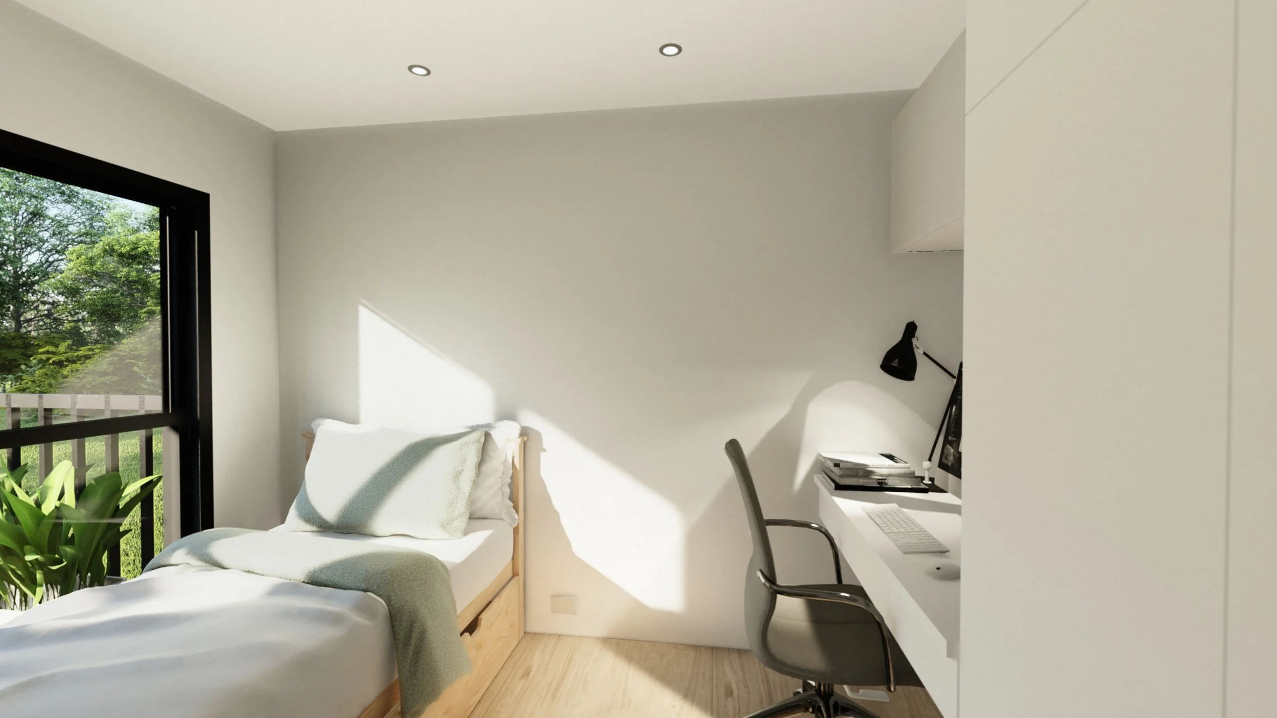 A minimalist bedroom with a single bed near a large window, a small white desk with a black desk lamp and an office chair, and a view of green trees outside.