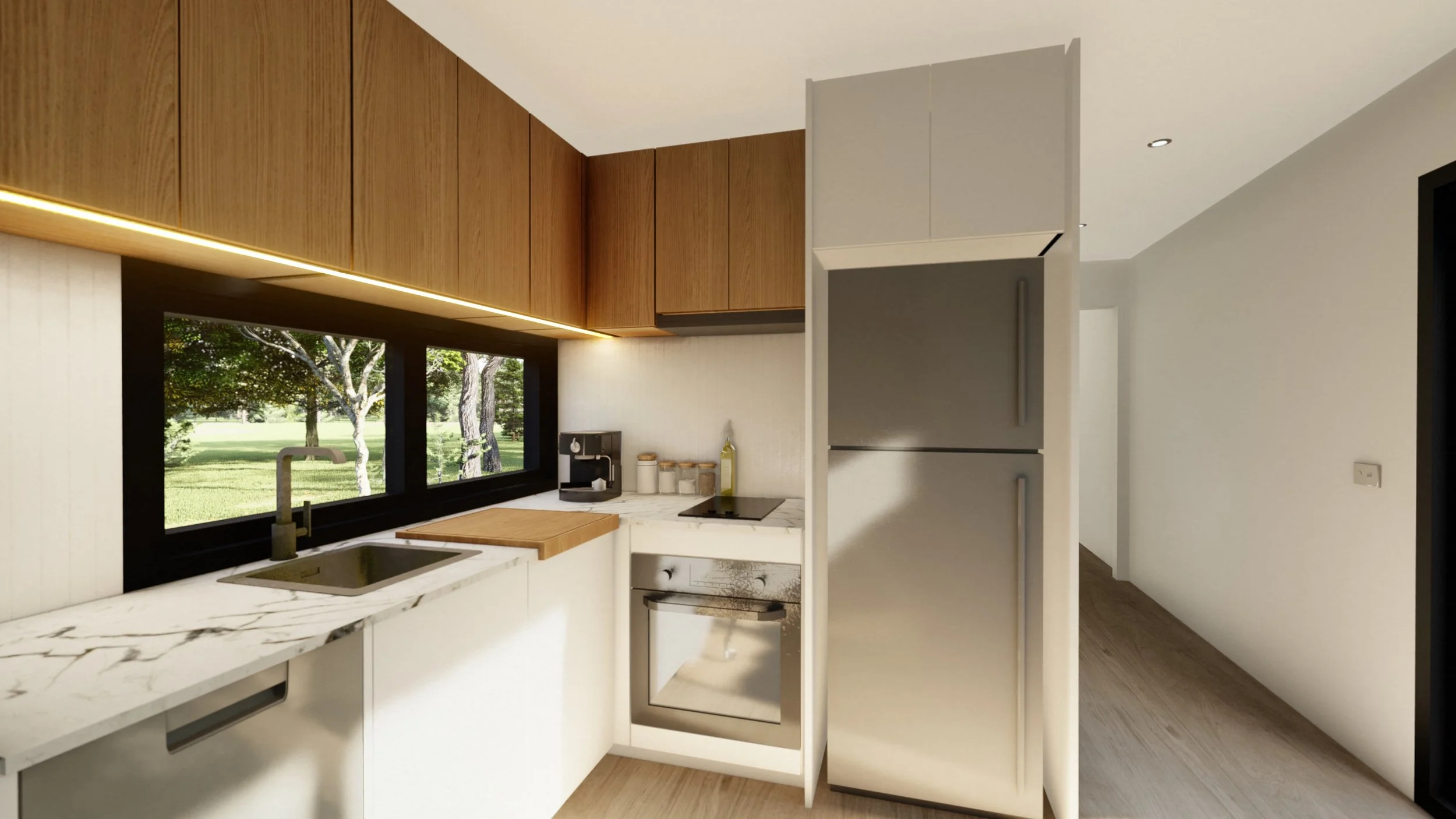 Modern kitchen with white marble countertops, wooden cabinets, black window, oven, small appliances, and a view of green trees outside.