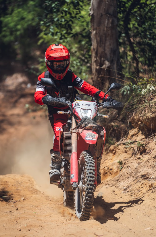 Rider navigating technical single track on a dirt bike during a Cairns off road motorcycle tour in Far North Queensland
