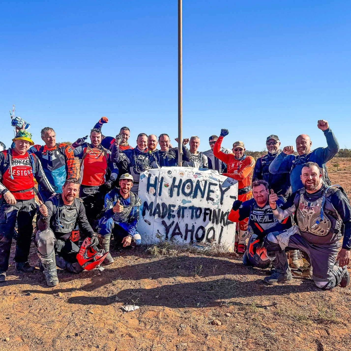 Adventure riders finishing a Simpson Desert crossing on a guided motorcycle tour through the Australian outback Finke Track