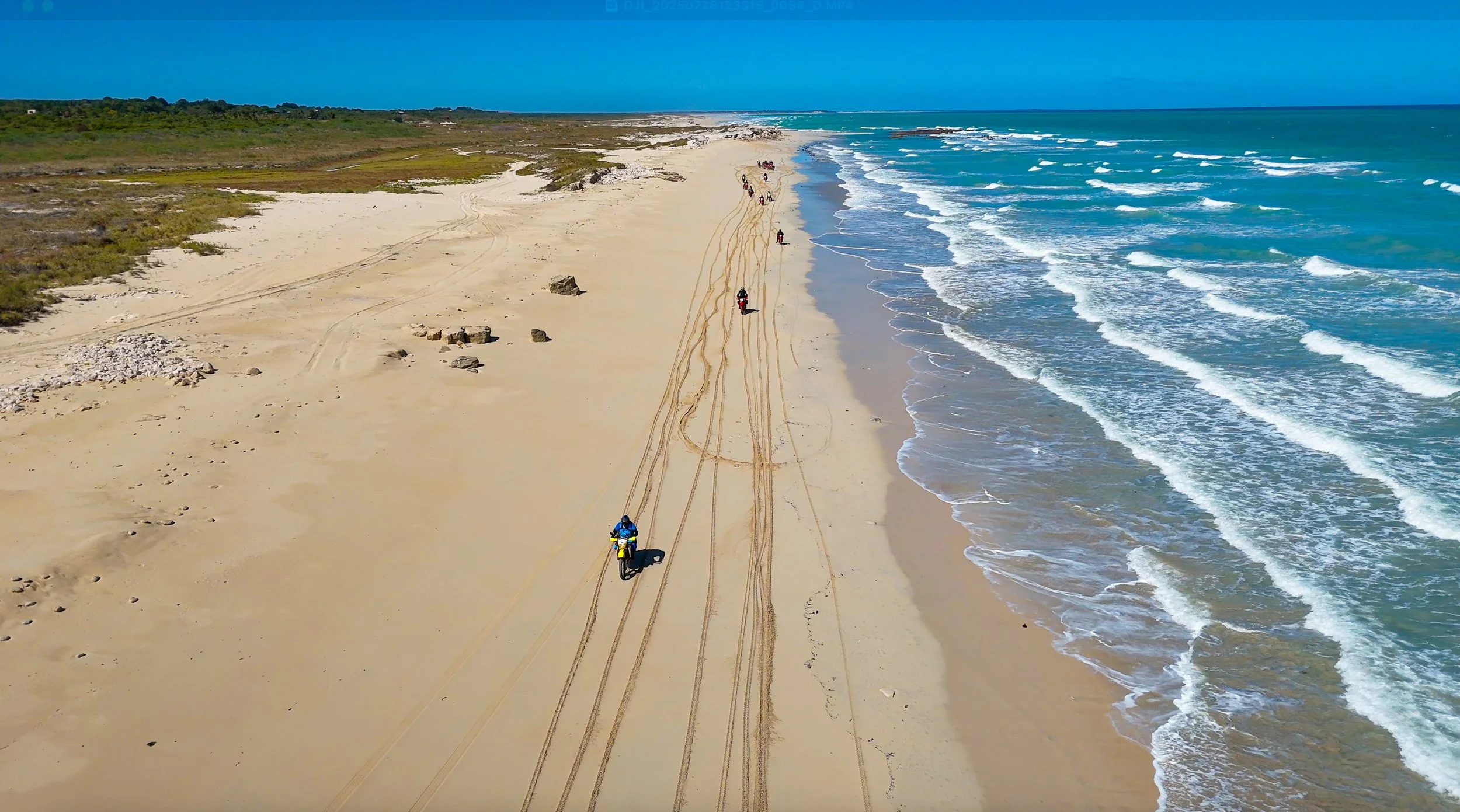 Dirt bike riders enjoying beach riding on an adventure motorcycle tour along the Western Australian coastline