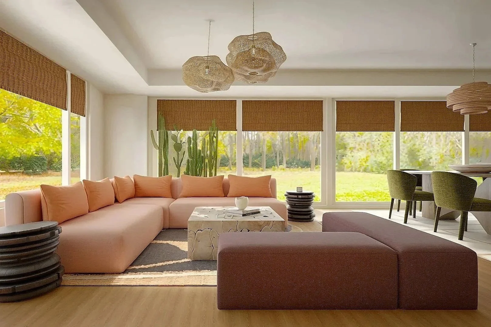 Bright living room with expansive windows overlooking green scenery, featuring a soft blush sectional, sculptural marble coffee table, cactus, and woven pendant lighting.