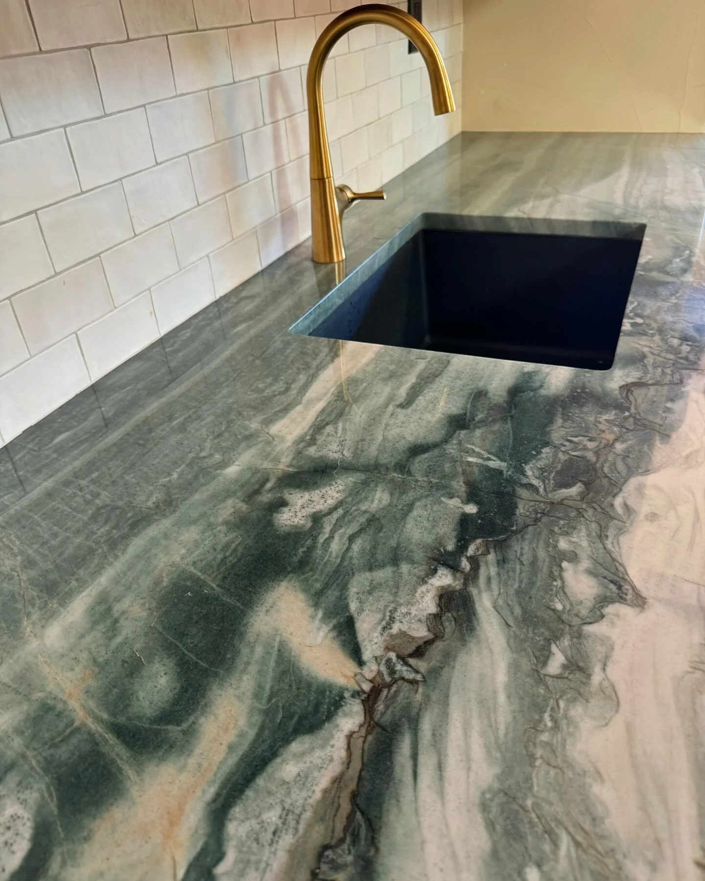 Guest suite featuring vintage carved chest and artisan textile wall hanging