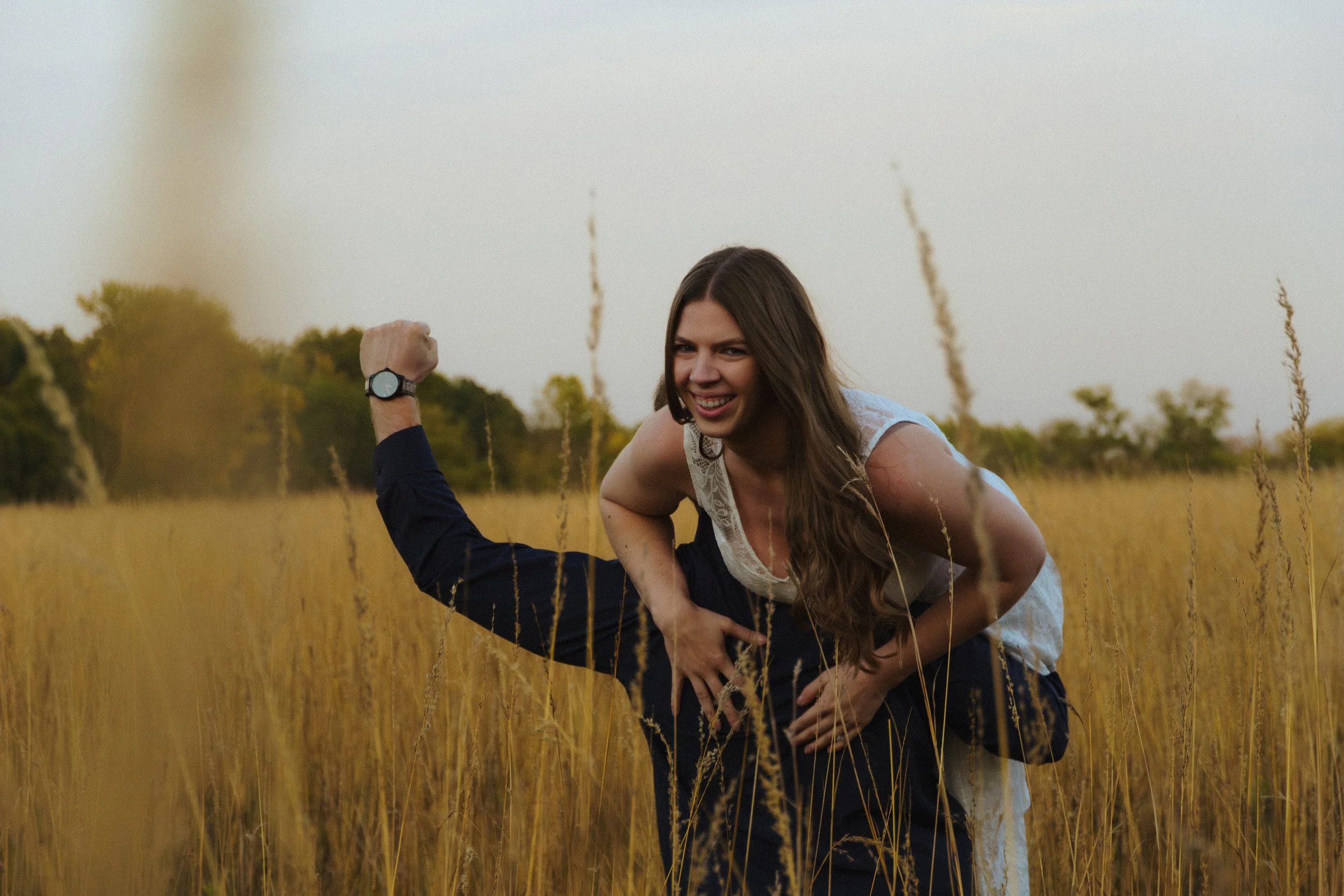 Fun engagement session in Elm Creek meadow, golden‑hour light.