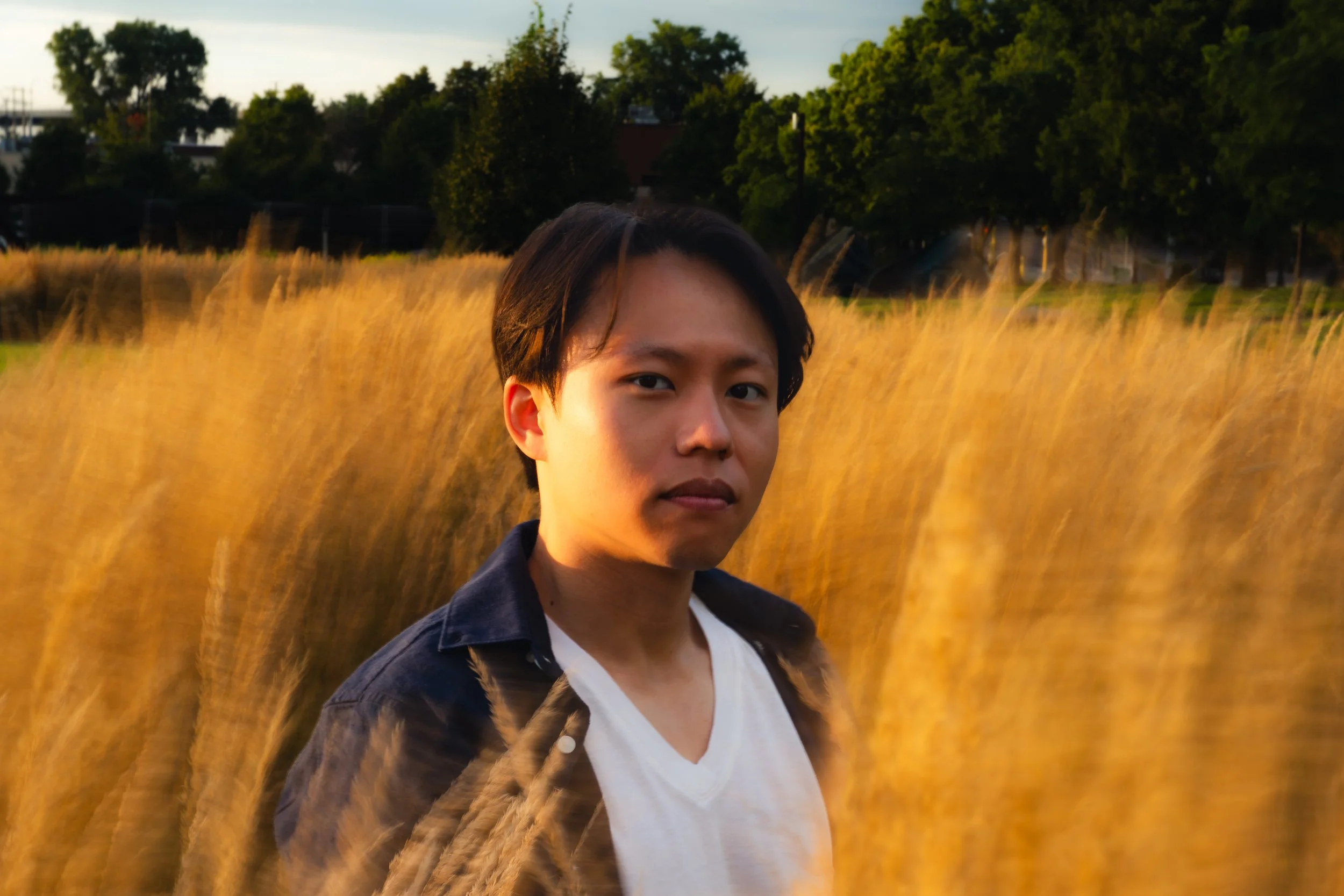Portrait at Minneapolis Sculpture Garden, golden-hour light in tall grass