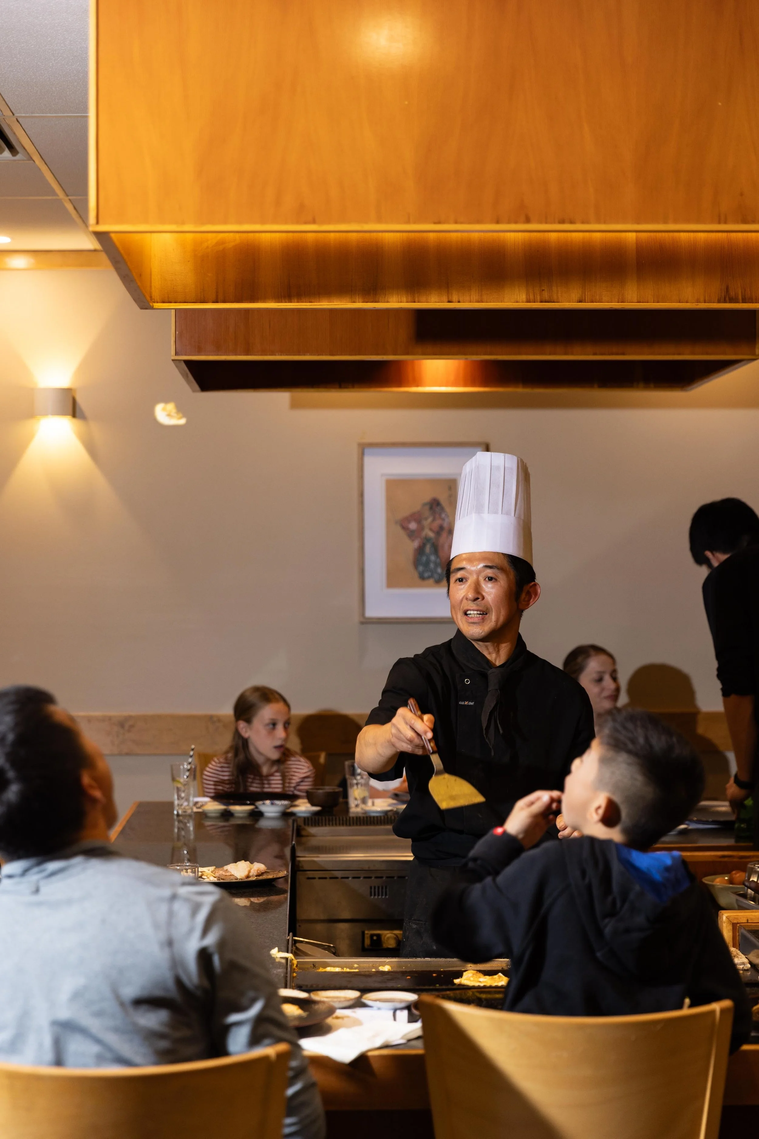 Family friendly restaurant Doncaster East - Chef serving food to family dining at teppanyaki