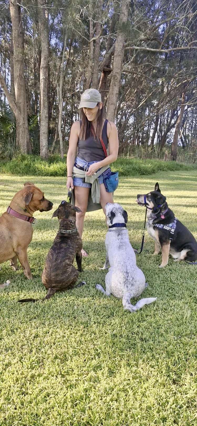 Stef with four dogs on leads in a park