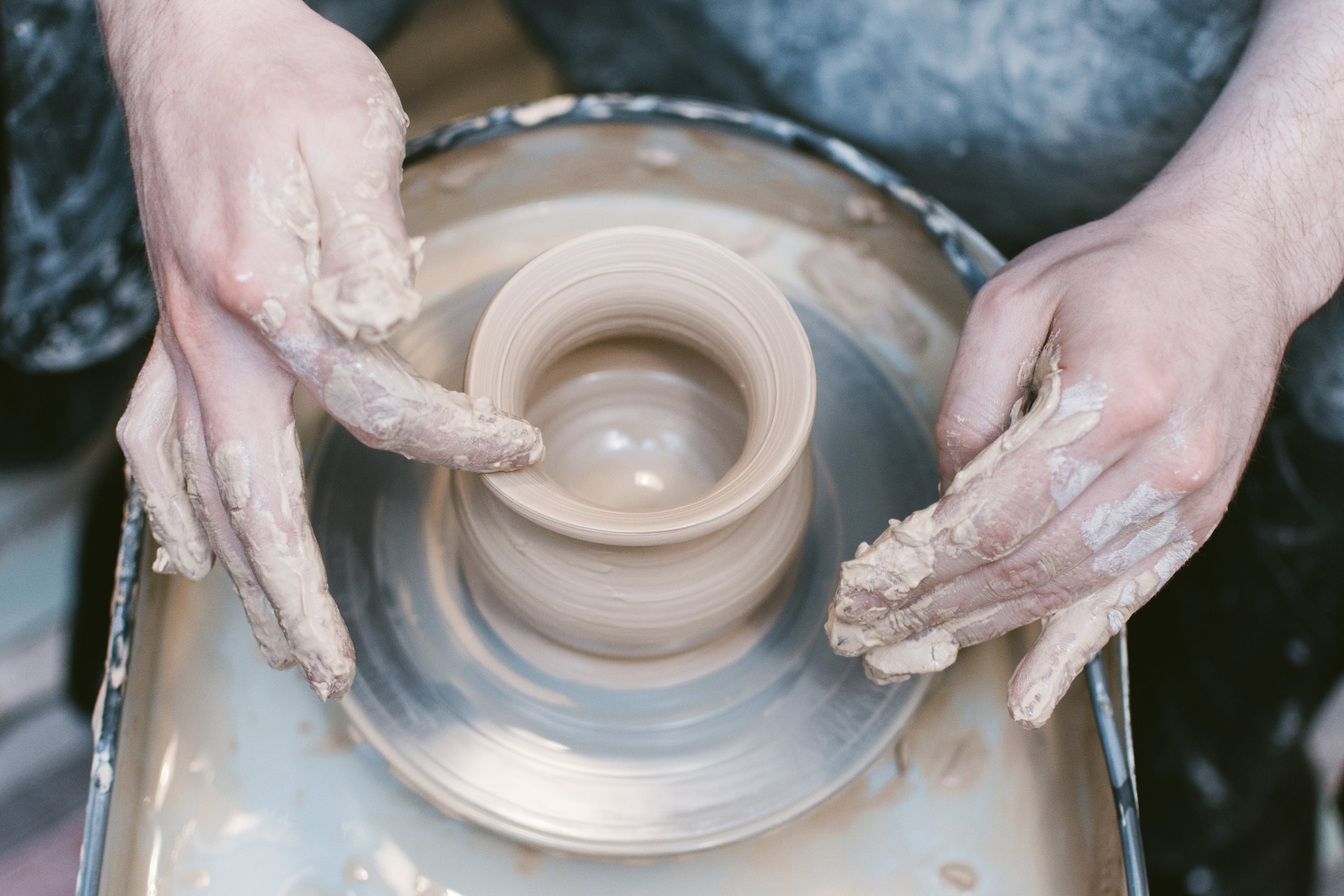 Pottery classes Munger Place students learning wheel throwing techniques 