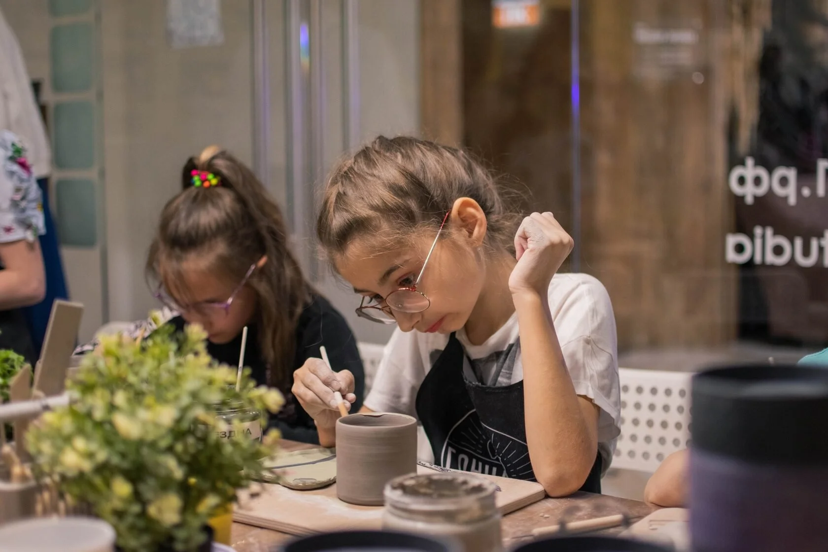 Students enjoying pottery classes Swiss Avenue   handbuilding clay   