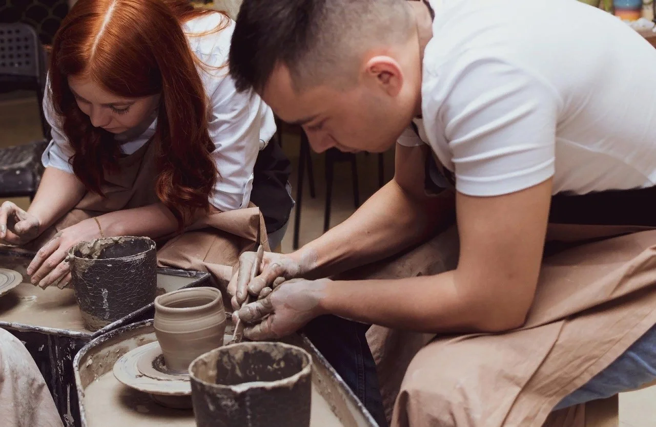 Pottery studio Junius Heights instructor demonstrating wheel throwing  