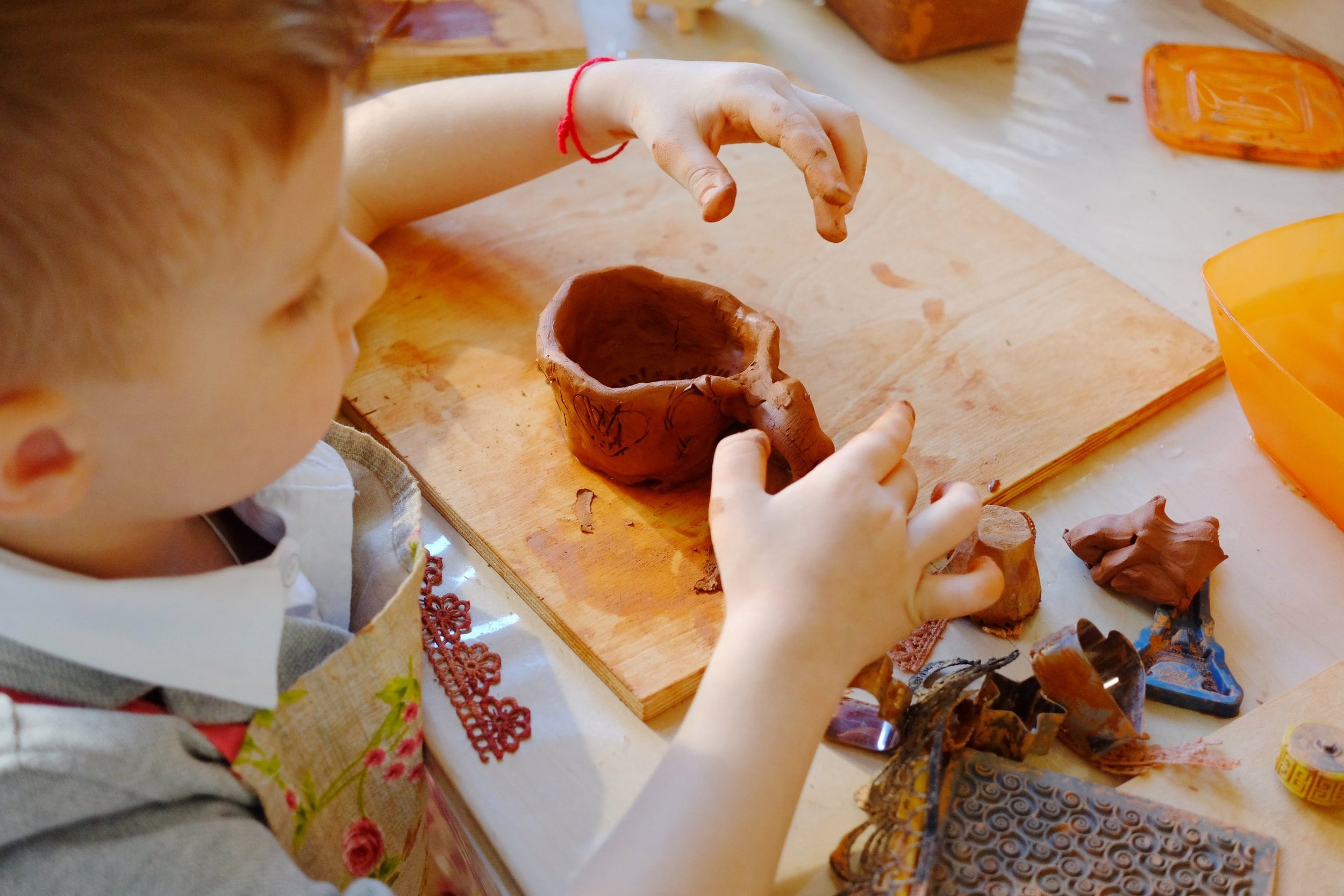Students shaping clay at a pottery studio in Greenland Hills    