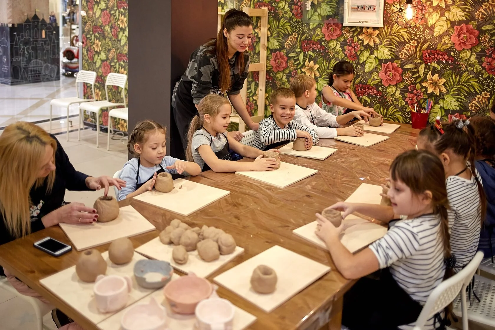 Beginners practicing clay techniques in pottery classes Swiss Avenue   